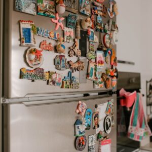 A collection of custom photo magnets on a fridge