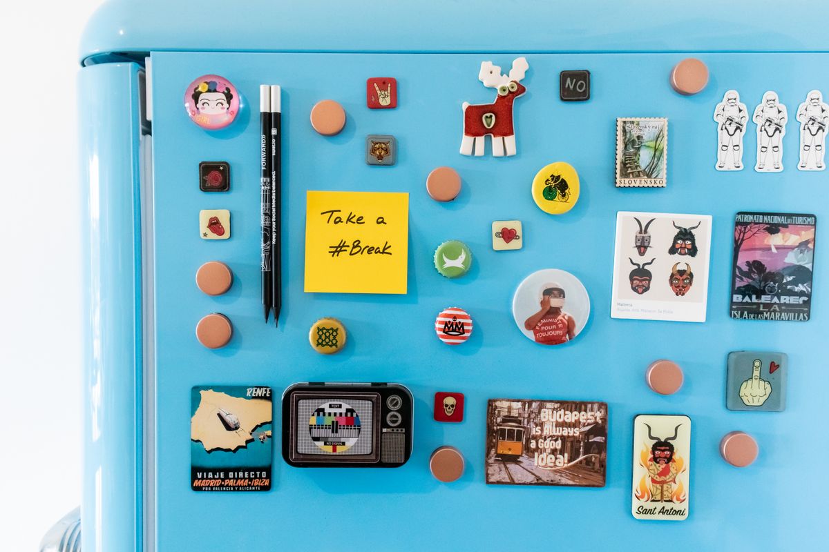 Blue fridge with colourful photo magnets